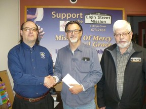 David Cook, left, Grand Knight of Knights of Columbus Council 1387, presents a check to Pastor Brad Hale and board member Gerry Newbury of the Elgin Street Mission. Supplied photo