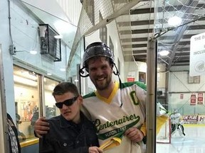 Jason Lamont, 18, from Seaforth accepted a jersey last year from Brendon Merritt, captain for the Huron East Centenaires. The team recently asked Lamont to announce some of their home games. (Courtesy of Facebook)