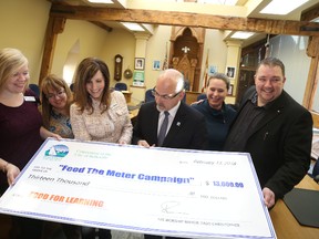 Jason Miller/The Intelligencer
The popular Feed the Meter campaign raised $13,000 in Belleville this past December. Pictured here celebrating the record year is  community development co-ordinator, (first from left) Vicky Struthers, program co-ordinator Kellie Brace, executive director Maribeth deSnoo, Mayor Taso Christopher, Cherie Hardie of the Hastings Prince Edward Learning Foundation and Don Udall, of Vision Transportation, which was one of this years donors.
