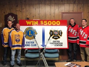 Above, members of the Exeter Lions Club and South Huron Fire Department gather in front of the board that people will have a chance to take a shot at during the second intermission. If the shooter gets the puck through the hole at the bottom of the board, they will win $5,000. Pictured above from (l-r) are Exeter Lions BJ Theophilopoulos, Mark Keller and South Huron Fire firefighters Bryan Denomme and chief Jeff Musser. (Handout/Exeter Lakeshore Times-Advance)