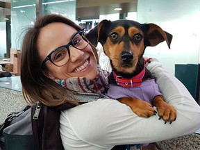 In this undated photo provided by Free Korean Dogs, Canadian figure skater Meagan Duhamel of Lively poses with her dog Moo-tae, right, in South Korea. Duhamel already has one life-changing souvenir from South Korea, and it’s not a medal. The Olympic pairs skater rescued a puppy from the Korean dog meat trade while competing in Pyeongchang last year, and she’s helping organize more adoptions while skating there at this year’s games. (EK Park/Free Korean Dogs via AP)