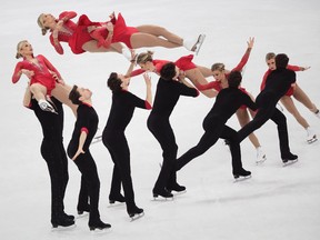 In this multiple exposure image, Canada's Kirsten Moore-Towers of St. Catharines, Ont., and Michael Marinaro of Sarnia, Ont., perform in the pairs figure skating short program in the Gangneung Ice Arena at the 2018 Winter Olympics in Gangneung, South Korea, on Wednesday, Feb. 14, 2018. (JULIE JACOBSON/The Associated Press)