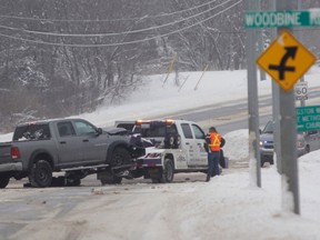 A pickup truck is towed away from the scene of a serious collision on Collins Bay Road in Kingston, Ont. on Sunday February 11, 2018. Kingston Police closed the road to conduct an investigation. Julia McKay/The Whig-Standard/Postmedia Network