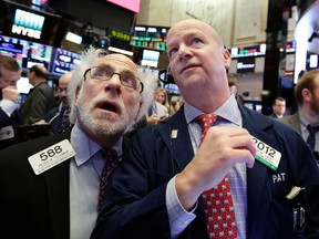 Richard Drew/The Associated Press
Traders Peter Tuchman, left, and Patrick Casey work on the floor of the New York Stock Exchange on Feb. 8.