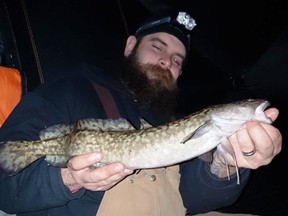 Local angler Terry Hawes shows off a typical-sized burbot caught on a recent outing. Terry's top bait is a heavy glow in the dark buck-shot rattle spoon bounced off the bottom to make a dust cloud, then hold the jig a couple inches off bottom and repeat. Photo supplied