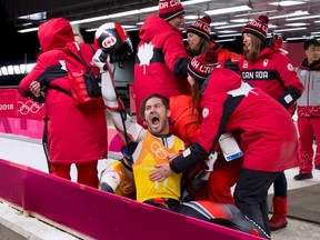 The Canadian luge team celebrates after their performance in the team relay competition, which would land them the silver medal, on Thursday, Feb. 15, 2018. (Jean Levac / Postmedia Network)