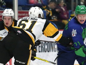 Nolan Hutcheson, right, of the Sudbury Wolves, slips past Riley Stillman, of the Hamilton Bulldogs, during OHL action at the Sudbury Community Arena in Sudbury, Ont. on Saturday February 17, 2018. John Lappa/Sudbury Star/Postmedia Network