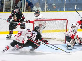 Alec DeKoning (No. 22 in black) stretches for the puck in front of Leamington Flyers goalkeeper Noah Hedrick during Saturday's Jr. 'B' hockey game at the Brock Street 'barn.' Sarnia won the contest 3-0. (Submitted photo by Shawna Lavoie)