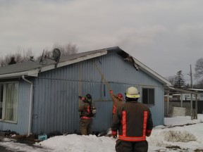 Fire crews work to put out a blaze before it consumed 4379 Old Highway 2 unit.