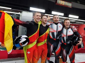 Thorsten Margis and Francesco Friedrich of Germany celebrate with Alexander Kopacz and Justin Kripps of Canada after the teams tied for the gold medal during the two-man bobsled final at the 2018 Winter Olympics in Pyeongchang, South Korea, Monday.
AP Photo/Andy Wong