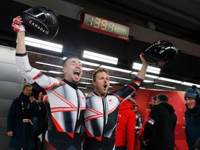 Driver Justin Kripps, right, and Alexander Kopacz of Canada celebrate after tying for the gold with Germany during the two-man bobsled final at the 2018 Winter Olympics in Pyeongchang, South Korea, Monday, Feb. 19, 2018. (AP Photo/Andy Wong)