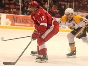 Soo Greyhounds' Boris Katchouk is chased by Sarnia Sting's Connor Schlichting during the third period at Essar Centre in Sault Ste. Marie, Ont., on Saturday, Feb. 17, 2018. (BRIAN KELLY/Postmedia Network)