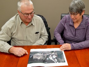 George and Agnes Dickenson look over their own farm’s emergency sketch, developed to help local emergency services navigate their farm if they are ever in a crisis situation. Melissa Schilz/Postmedia Network