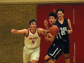 Woodstock Collegiate Institute Red Devils Callaghan Bullen, left, and College Avenue Knights Terell Lloyd aim to get a loose ball in Woodstock, Ont. on Tuesday February 6, 2018 at WCI in their TVRA Southeast Division senior boys' basketball game. The TVRA Southeast divisional finals are today with close to 20 Oxford County teams playing. Greg Colgan/Woodstock Sentinel-Review/Postmedia Network