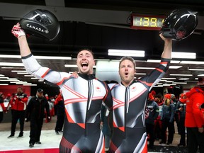 Justin Kripps (R) and Alexander Kopacz (L) of Canada celebrate their gold medal in the men's two-man bobsled at the Olympic Sliding Centre during the 2018 Winter Olympics in South Korea, February 19, 2018. (Jean Levac/Postmedia Network)