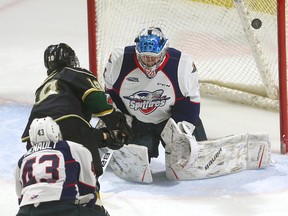 London Knights forward Liam Foudy rings a shot off the post on Windsor Spitfires goalie Michael DiPietro as the Spitfires? Louka Henault defends during an Ontario Hockey League game Monday at Budweiser Gardens. The Knights won 3-1. (MIKE HENSEN, The London Free Press)