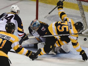 Kingston Frontenacs' Linus Nyman scores his second of the game past Barrie Colts' Leo Lazarev during the third period of Ontario Hockey League action at the Rogers K-Rock Centre in Kingston on Monday.  With the 5-2 win, the Fronts clinched a playoff spot. (JULIA MCKAY/The Whig-Standard)