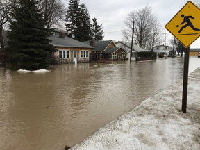 Flooding caused by heavy rain has closed roads and left some homes partly submerged in Port Bruce, south of St. Thomas, on Feb. 21. A bridge in the community collapsed days later. (Derek Ruttan/The London Free Press)