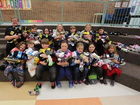 Bath Public School Grade 5/6 teacher Jennifer Morrisey and Grades 1 to 6 students show off more than 1,200 pairs of socks that they collected for the homeless. Meghan Balogh/The Whig-Standard
