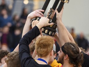 Members of the La Salle Black Knights senior boys basketball team celebrate the club's win over the Frontenac Falcons in the Kingston Area Secondary Schools Athletic Associations senior boys basketball final at the Queen's Athletics & Recreation Centre on Monday. (Julia McKay/The Whig-Standard)