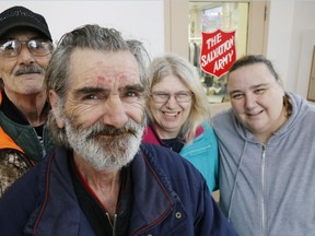 Luke Hendry/The Intelligencer 
Bill Horsburgh, foreground, gathers with his brother, Mike, cousin, Karen Fair, second from right, and niece, Jenn Courtney, Tuesday, at the Salvation Army thrift store in Belleville. After decades apart, Horsburgh has been reunited with many relatives since he became an Army volunteer.