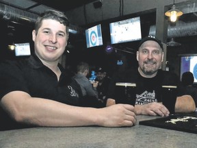 Herald Haus Brewing Co. head brewer Jeff Macdonald and managing partner Dan Graver celebrate the launch of Dingman Dark lager Friday in Stratford. (GALEN SIMMONS/Postmedia News)