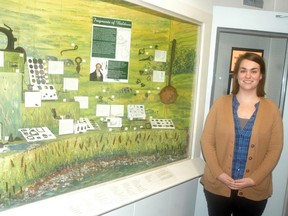 Wallaceburg Museum curator Andrea Lalonde shows off a new permanent exhibit at the museum that features artifacts unearthed from the Baldoon Settlement site. The artifacts were found by Richard Miller, who donated his collection to the museum. David Gough/Postmedia Network