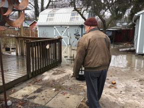 Brian Chase surveys his backyard and shed in Port Bruce flooded after heavy rainfall and unseasonably warm weather Tuesday. He and other residents are picking up the pieces after their second flood of 2018 in their Elgin County town, the first in mid-January.