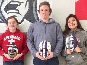 From left: Kylie Crawford, Noah Brant and Kendall Tabobandung with their hockey goalie mask designs, patterned after the fibreglass creations worn by netminders in the 1960s and '70s. (Submitted photo)