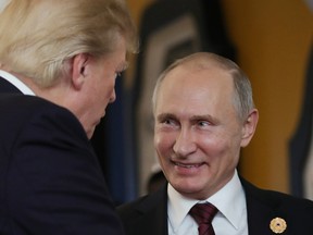 In this file photo taken on November 11, 2017 US President Donald Trump (L) chats with Russia's President Vladimir Putin as they attend the APEC Economic Leaders' Meeting, part of the Asia-Pacific Economic Cooperation (APEC) leaders' summit in the central Vietnamese city of Danang on November 11, 2017. (AFP/Getty Images)