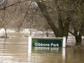 The Gibbons Park sign shows the depth of the flood waters in the park in London, Ont.  Photograph taken on Wednesday February 21, 2018.  Mike Hensen/The London Free Press/Postmedia Network