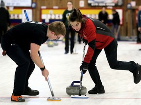 Second Liam Bruce, left, and vice Ashley Scott of the North Lambton Eagles sweep during the LKSSAA boys' curling final against the McGregor Panthers at the Sydenham Community Curling Club in Wallaceburg, Ont., on Wednesday, Feb. 21, 2018. Lead Kelby Page and skip Jayden Levac are the other members of the Eagles, who won 9-1. Both finalists advance to the SWOSSAA championship March 6, 2018, in Windsor, Ont. (Mark Malone/Chatham Daily News/Postmedia Network)