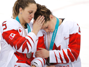 Canada defenceman Lauriane Rougeau and Canada forward Rebecca Johnston console each other after losing to the United States. LEAH HENNEL / POSTMEDIA