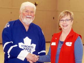 Gerry Flynn is congratulated by Canadian Blood Services volunteer Patty Henderson for donating blood for his 150th time last month.