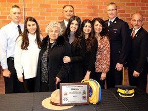 TIM MEEKS/THE INTELLIGENCER
A special ceremony, hosted by the Dave Mounsey Memorial Fund, was held Thursday at the Quinte Sports and Wellness Centre to present the Fortis family of Belleville with a plaque and Automated External Defibrillator to be placed at QSWC in honour of RCMP Constable Gerald Fortis, who was killed in the line of duty December 25, 1997 in Chilliwack, BC. On hand for the presentation were, from the left: Mark Fluhrer, director of recreation, culture and community services for the City of Belleville, OPP Constable Patrick Armstrong, Natalia Fortis, Helen Fortis, Michael Fortis, Patrina Fortis, Eleni Fortis, Gina Fortis, RCMP Inspector Andrew Cowan, Mayor Taso Christopher, and RCMP Constable Nathan Murano.