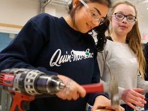 Tim Miller/The Intelligencer
Nicole Denison pounds down a nail while fellow Grade 9 Nicholson Catholic College student Kaylynn Akey looks during a Young Women's Career Exploration Event at Loyalist College on Thursday in Belleville.