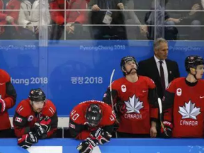 Canadian players stand dejectedly after losing to Germany on Feb. 23.