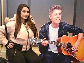 Alexandra Wilson, of Whitby, has her picture taken with Justin Bieber on the Steps of Avon at the Stratford Perth Museum. (Galen Simmons/Postmedia Network )