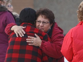 Family and supporters hug outside court as a provincial court judge decides if a teen who pleaded guilty in the 2016 shooting spree that left four people dead and seven others wounded will be sentenced as an adult in La Loche, Sask. on Friday.THE CANADIAN PRESS/Jason Franson