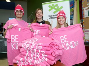 Boys and Girls Club of Kingston and Area staff, from left, Graham Oswald, co-ordinator of Kidz Zone and Par-T-Perfect, Kori Cembal, manager of volunteer services and special events, and Heather Hayhow, manager of fund development at the club's west-end hub, at the Frontenac Mall on Friday with pink T-shirts as part of the club's annual anti-bullying campaign. (Ian MacAlpine/The Whig-Standard)