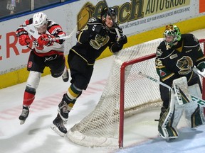 Ottawa 67?s forward Travis Barron slams into Knights defenceman Alec Regula behind the London net during the first period of their OHL game at Budweiser Gardens on Friday night.  (MORRIS LAMONT, The London Free Press)