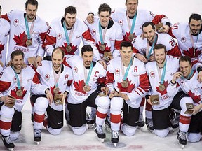Canada captain Chris Kelly of the AHL Belleville Senators celebrates with his teammates following a 6-4 win over the Czechs in the bronze-medal game of the men's Winter Olympics hockey tournament Saturday in Pyeongchang, South Korea. (Nathan Denette/Canadian Press)