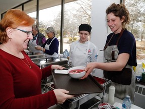 Vendor Chris Herrington of Tweed receives a bowl of beet soup  from chef Alexandra Feswick at the Empty Bowls event in support of the Gleaners Food Bank and Quinte Region Food Share Saturday at Loyalist College in Belleville. With them was first-year culinary student Candace Dulmage of Trenton. Luke Hendry/Belleville Intelligencer/Postmedia Network