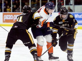 Flint Firebirds' Ty Dellandrea (53) is sandwiched by Sarnia Sting's Cam Dineen (4) and Nick Grima (7) in the second period at Progressive Auto Sales Arena in Sarnia, Ont., on Sunday, Feb. 25, 2018. (Mark Malone/Chatham Daily News/Postmedia Network)