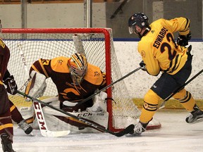 Queen’s Gaels’ Luke Edwards tries to score on Concordia Stingers goalie Marc-Antoine Turcotte during Game 3 of their Ontario University Athletics men’s hockey quarter-finals at the Memorial Centre on Sunday. Concordia won 3-2 in overtime to take the best-of-three series, 2-1. (Ian MacAlpine/The Whig-Standard/Postmedia Network)