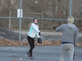 Kasia Donovan plays catch with Prashant Agrawal in a softball field at City Park in Kingston on Monday February 26, 2018. (Steph Crosier/The Whig-Standard)