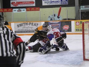 Above, Hawks forward Liam Melady goes nose to nose with Dolphins goaltender Riley Brown during the first period on Feb. 23. Melady didn’t score on the play but scored twice in game one. (Terry Heffernan/Exeter Lakeshore Times-Advance)