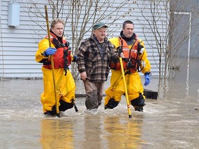 Members of the Chatham-Kent Fire & Services dive team were at the Siskind and Pegley Court area of Chatham on Saturday to assist residents whose homes were flooded. Louis Pin/Postmedia Network