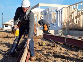 Abe Penner, a builder with Doug Tarry Homes, works on a home build in the Harvest Run subdivision on the southeast side of St. Thomas. High demand and low supply have pushed prices up in the region as the average cost to buy a house is 20 per cent higher this year than last. (Louis Pin // Times-Journal)