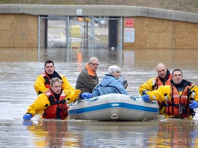 Members of the Chatham-Kent Fire & Services dive team arrived on scene at the Siskind and Pegley Court area of Chatham, Ont. on Saturday, Feb. 24 to assist some residents whose homes were flooded. Louis Pin/Postmedia Network